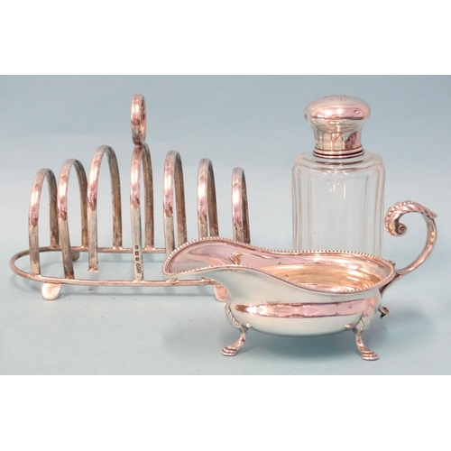 408 - An Edwardian silver sauce boat of small size with leaf-capped scroll handle, Joseph Rogers & Son... 