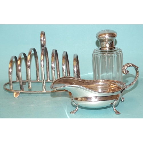 408 - An Edwardian silver sauce boat of small size with leaf-capped scroll handle, Joseph Rogers & Son... 