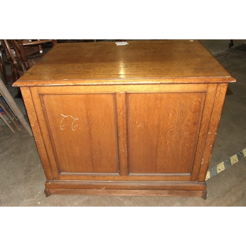 45 - An Edwardian oak plan chest of seven drop-down-fronted drawers, on plinth base and panelled back, wi... 