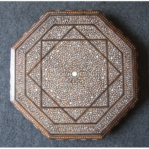 48 - An Indian hardwood octagonal folding table inlaid with ivory and bone depicting profuse foliate deco... 