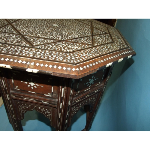 48 - An Indian hardwood octagonal folding table inlaid with ivory and bone depicting profuse foliate deco... 