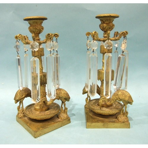 71 - A pair of Victorian gilt-metal table lustre candlesticks, each with the cut drops suspended from a c... 