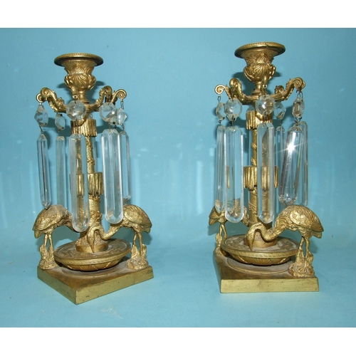 71 - A pair of Victorian gilt-metal table lustre candlesticks, each with the cut drops suspended from a c... 