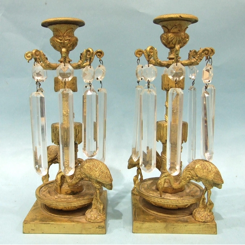 71 - A pair of Victorian gilt-metal table lustre candlesticks, each with the cut drops suspended from a c... 