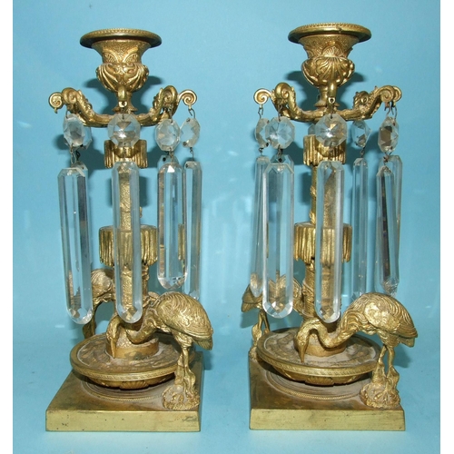 71 - A pair of Victorian gilt-metal table lustre candlesticks, each with the cut drops suspended from a c... 