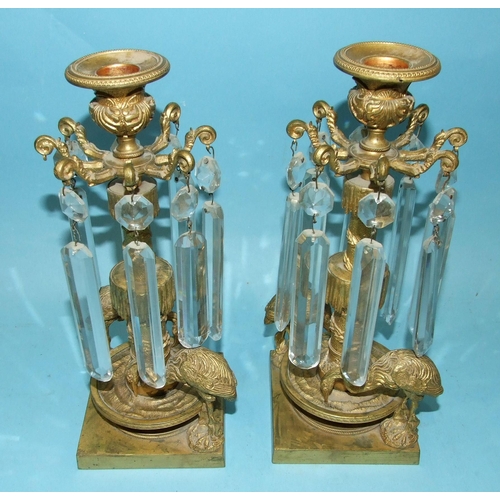 71 - A pair of Victorian gilt-metal table lustre candlesticks, each with the cut drops suspended from a c... 