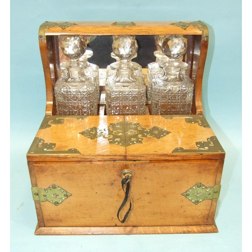 72 - A Victorian/Edwardian Tantalus and games compendium fitted with three decanters, original matching g... 