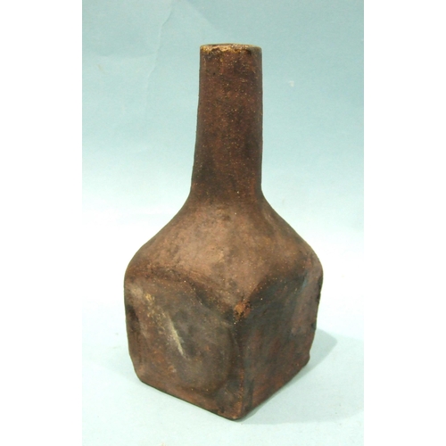 90 - A heavy stoneware bottle of square form with slender neck, 20.5cm high.