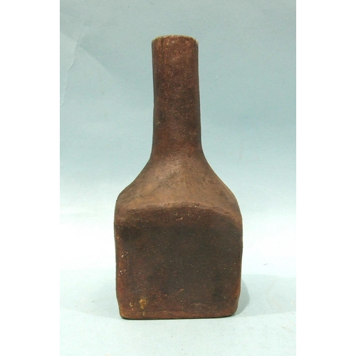 90 - A heavy stoneware bottle of square form with slender neck, 20.5cm high.