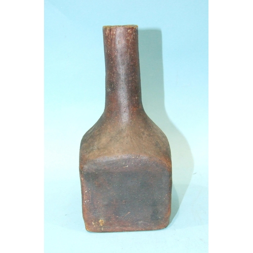 90 - A heavy stoneware bottle of square form with slender neck, 20.5cm high.