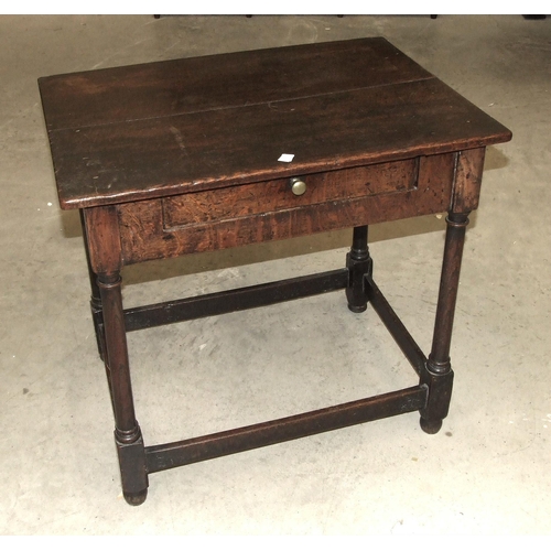 36 - An antique oak side table, the rectangular top above a frieze with drawer, on turned legs joined by ... 