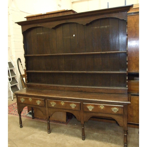 37 - An 18th century oak dresser base fitted with three drawers, on short turned legs, 207cm wide, 49cm d... 