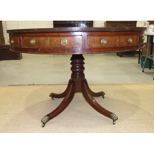 42 - An early-19th century mahogany drum table, the top with replacement leather surface above four friez... 