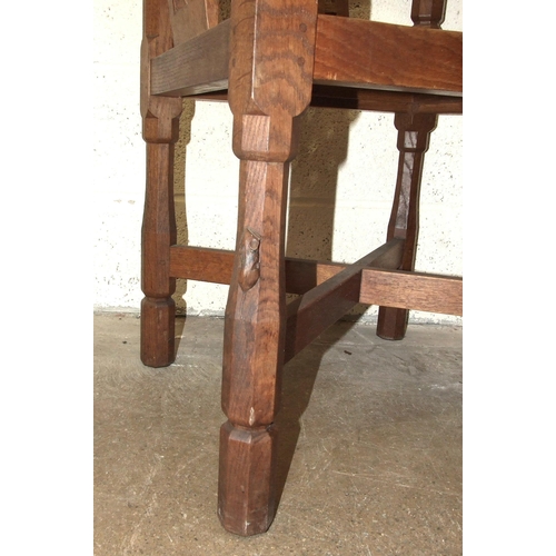 60 - Robert 'Mouseman' Thompson Workshop, an English monk's chair, the curved back and outswept arms abov... 