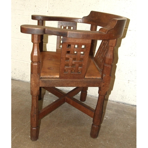 60 - Robert 'Mouseman' Thompson Workshop, an English monk's chair, the curved back and outswept arms abov... 