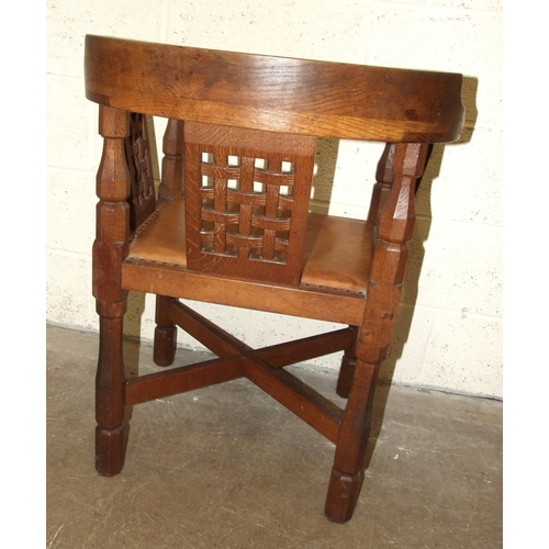 60 - Robert 'Mouseman' Thompson Workshop, an English monk's chair, the curved back and outswept arms abov... 