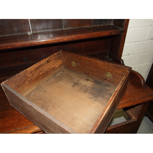 62 - An 18th century oak dresser with three-shelf plate rack, the base with three drawers, on turned supp... 