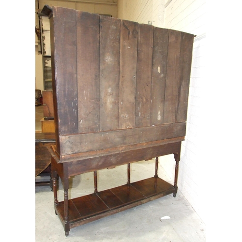 62 - An 18th century oak dresser with three-shelf plate rack, the base with three drawers, on turned supp... 