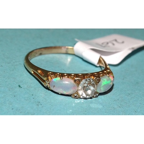 267 - An unusual opal and diamond ring claw-set an oval old-cut diamond of approximately 0.4cts between tw... 