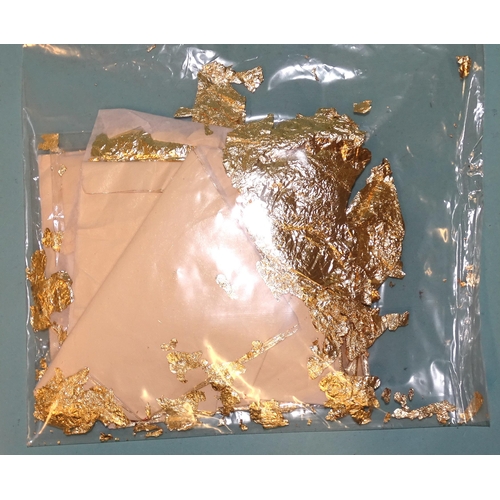 318 - A small quantity of gold-coloured metal leaf on 14 x 14cm tissue paper squares, gross weight 41g.... 