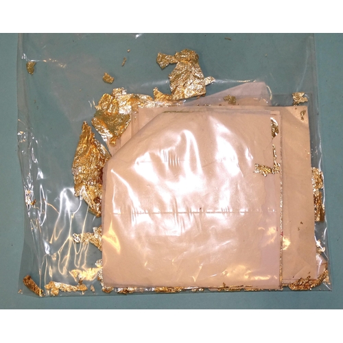 318 - A small quantity of gold-coloured metal leaf on 14 x 14cm tissue paper squares, gross weight 41g.... 