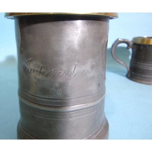 108 - Three graduated pewter and brass-rimmed measures with ER and GR marks, 14cm, 10.5cm and 8cm high and... 