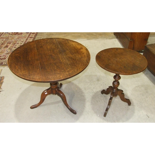 50 - An antique oak country circular tripod table on turned column and shaped legs, 53cm diameter and a l... 