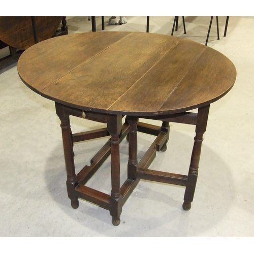 52 - A smaller antique oak oval gate-leg table on turned legs joined by stretchers, 92 x 104cm open.... 