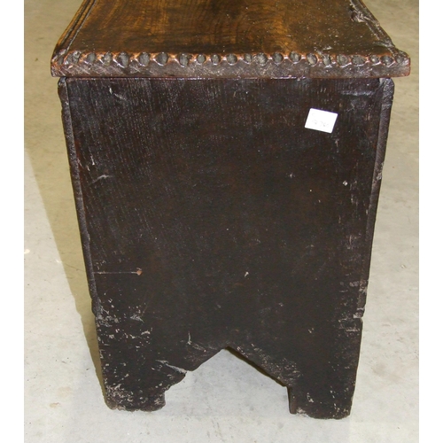 53 - An antique oak six-plank coffer, 102cm wide, 45cm high.