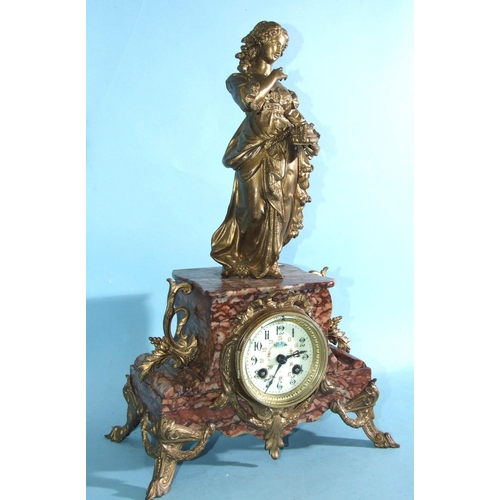 69 - A late-Victorian marble and metal-mounted mantel clock surmounted by a robed female figure and havin... 