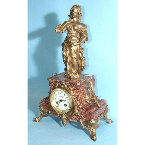 69 - A late-Victorian marble and metal-mounted mantel clock surmounted by a robed female figure and havin... 