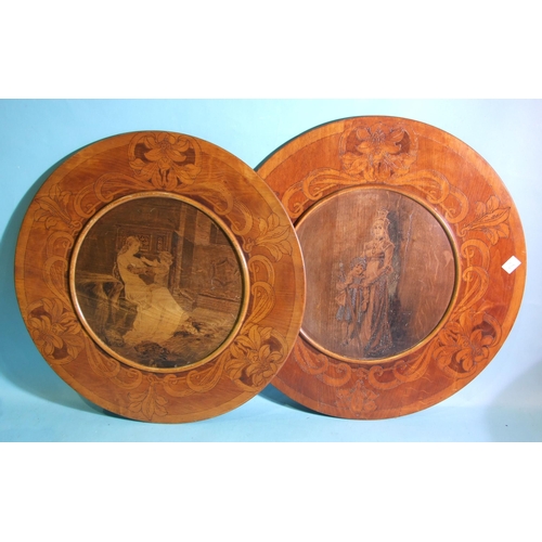 75 - A pair of pokerwork wood circular chargers decorated with a young woman and child, each signed in po... 