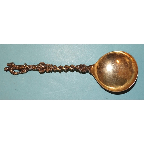 338 - An 18th century Dutch cast silver-gilt spoon, the pierced twist handle with figure terminal, the bow... 