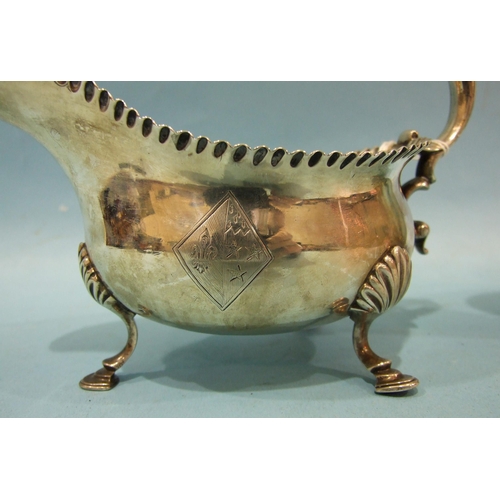 430 - A pair of George III silver sauce boats with gadrooned rims and scroll handles, on three shell suppo... 