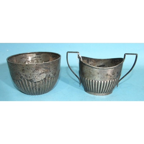 439 - A silver oval-shaped two-handled half-gadrooned sugar bowl, 8cm high, Birmingham 1900 and a circular... 