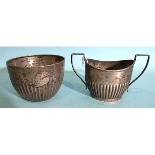 439 - A silver oval-shaped two-handled half-gadrooned sugar bowl, 8cm high, Birmingham 1900 and a circular... 