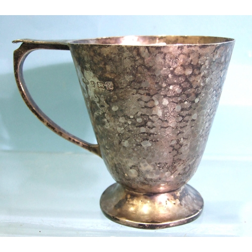 455 - An Arts & Crafts silver hammered mug on circular foot (dented), 8.5cm high, by Albert Edward Jon... 