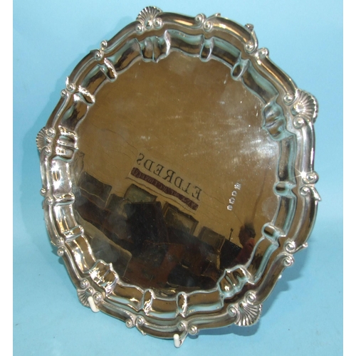 460 - An Elizabeth II silver salver with moulded and shell border, on three claw and ball feet, 25cm diame... 