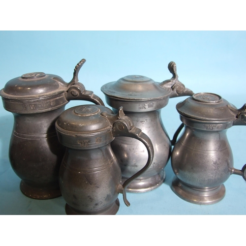 112 - A collection of Scottish pewter imperial baluster measures with hinged lids: ½-Pint, Gill (x2... 