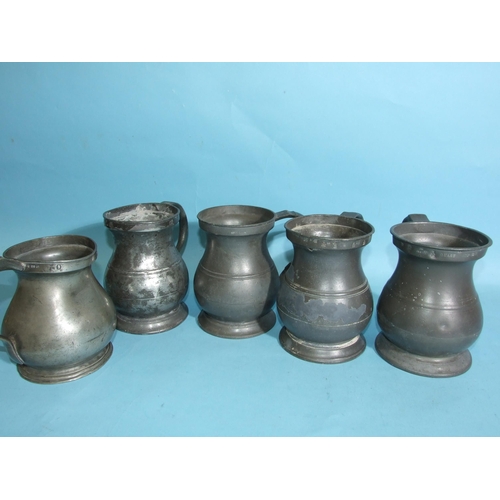 114 - Five pewter quart measures and four pint measures, all of baluster shape and bearing VR, GR and ER c... 