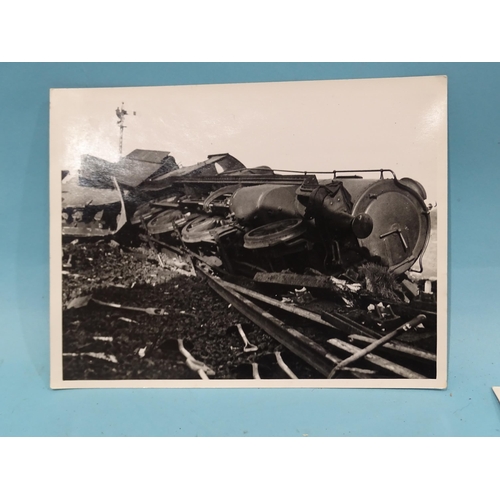 185 - Seven 1930's press photographs, six of which show a derailment of a locomotive, coaches and wagons a... 