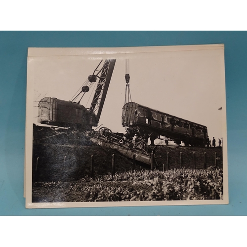 185 - Seven 1930's press photographs, six of which show a derailment of a locomotive, coaches and wagons a... 