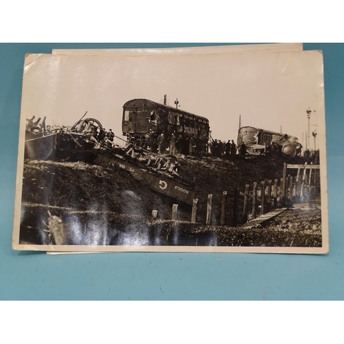 185 - Seven 1930's press photographs, six of which show a derailment of a locomotive, coaches and wagons a... 