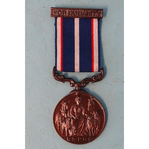 210 - An RSPCA bronze medal for animal life saving awarded to Charles E. Crossman, 1945, with 