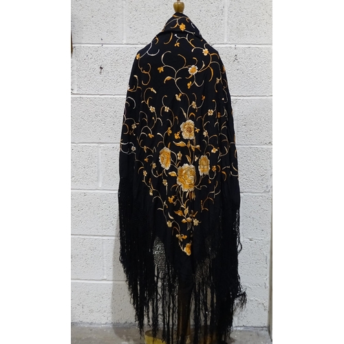 304 - A large Chinese black silk fringed shawl embroidered overall with orange flowers, approximately 145c... 