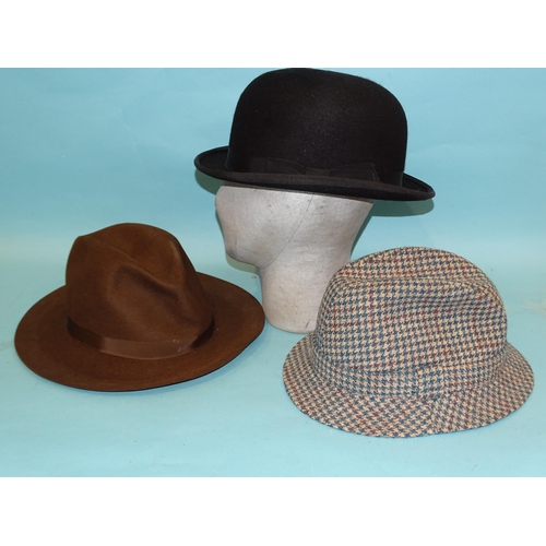 311 - A Lincoln Bennett & Co. bowler hat, size 7½, a brown felt trilby, size large and a tweed ... 