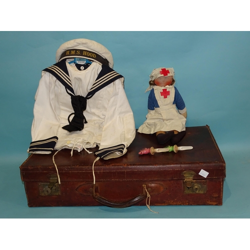 316 - A naval uniform for a child, with cap for HMS Hood, a rag doll in nurse's uniform, two ceramic wine ... 