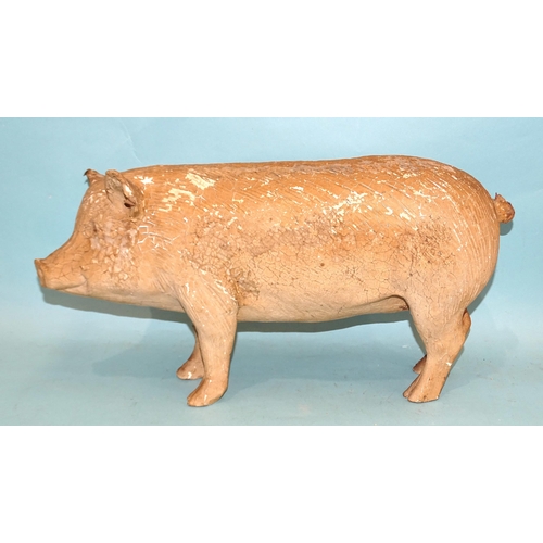 318 - A large composition figure of a pig, well-moulded with painted eyes, (paint flaking), 47cm long, 25c... 