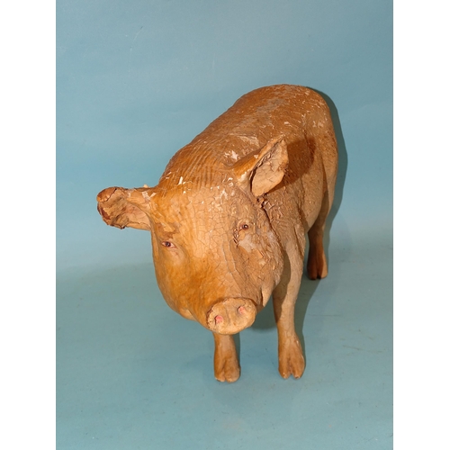 318 - A large composition figure of a pig, well-moulded with painted eyes, (paint flaking), 47cm long, 25c... 