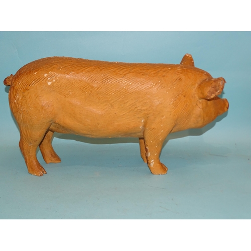 318 - A large composition figure of a pig, well-moulded with painted eyes, (paint flaking), 47cm long, 25c... 